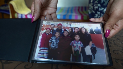 Chechi Sherpa, his eldest daughter holds up the last family photo taken together with their father and grandparents.