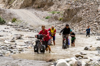 Getting feet wet to navigate scores of mountain streams and arms of the Bartang valley is a daily affair. The crossing slows us down enough for village kids who accompanied us for a few kilometres to catch up.