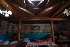 A view of the wooden pillars and beams that support the skylight that forms the central living area of a traditional Pamiri house.