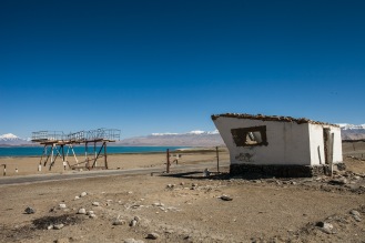 An old Soviet bus stand and remnants of a border guard lookout post mark the entry into Karakul, a Kyrgyz village that is now a part of Tajikistan as serves as an entry point into the Pamirs when coming from Kyrgystan.