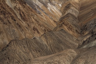a close-up view of the layers of stratified rocks of the Pamir Mountains that date back to the Cretaceous Period.